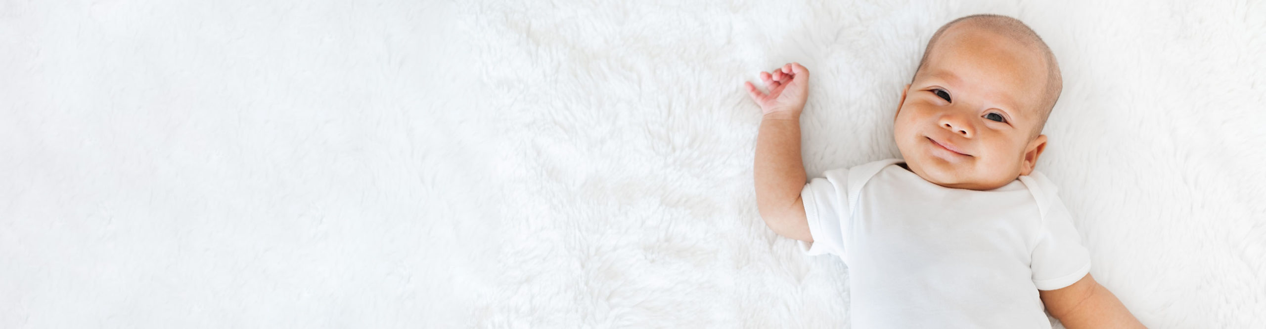 Portrait newborn baby happy over white background, topview